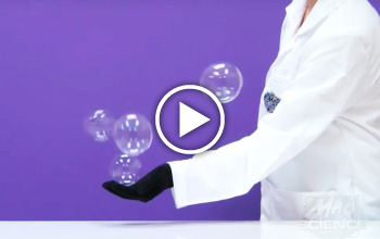 A Mad Science instructor catching balloons in her hand
